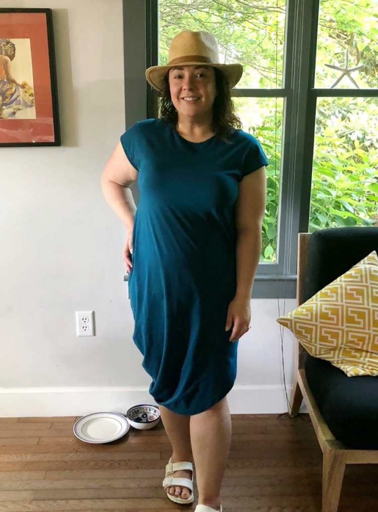 Alison in a blue Universal Standard Iconic Geneva dress and straw hat in vacation