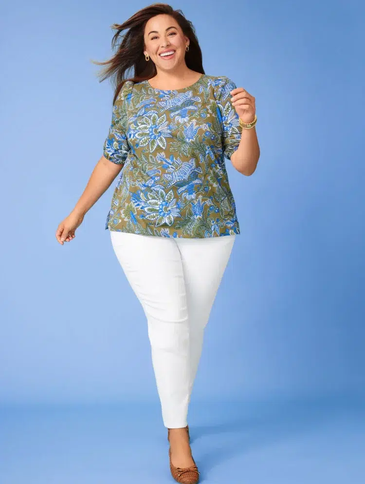 a model wearing a printed t-shirt with a pair of white Talbots slim ankle jeans