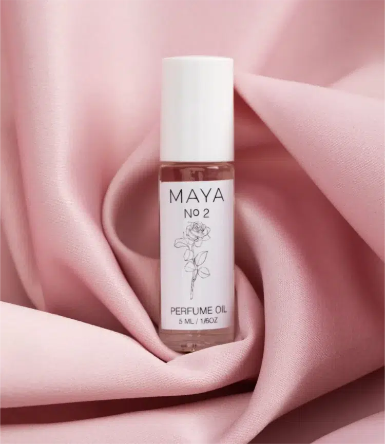 maya no 2 fragrance oil sitting on pink satin