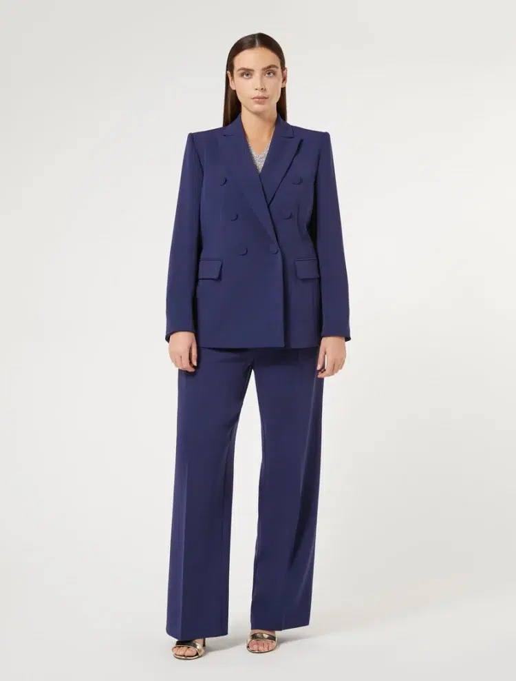 A navy double breasted pantsuit on a Marina Rinaldi model