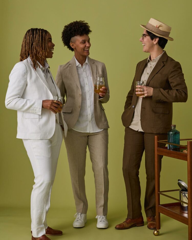 Three individuals wearing pantsuits from retailer Kirrin Finch