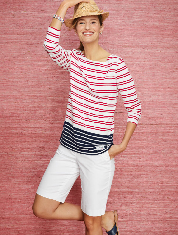 a Talbots model wearing the brand's 10.5" Perfect shorts with a striped Breton top and straw hat