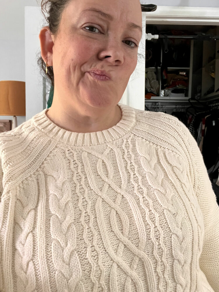 Alison wearing the ABLE Claudette fisherman sweater showing how it emphasizes her bust and shoulders