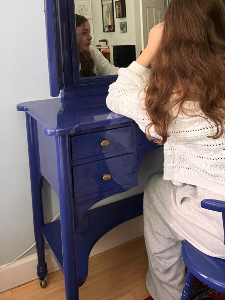 daughter sitting at the lacquered dressing table