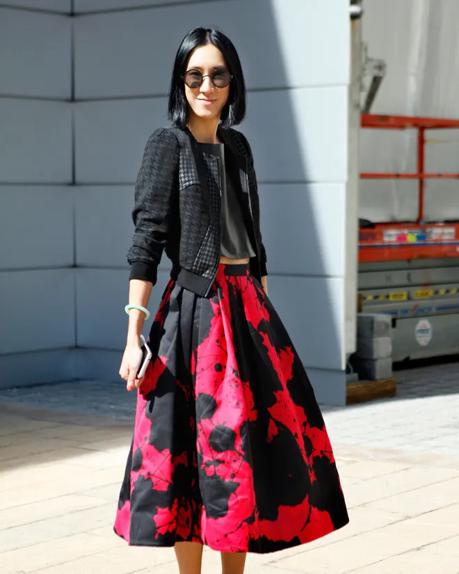 eva chen, NYFW 2013 wearing a red and black Tibi full midi length skirt with a black leather cropped tank and black bomber jacket