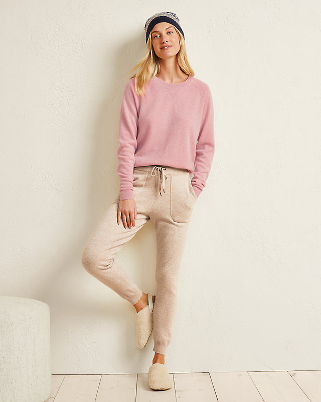 Model wearing a Garnet Hill Essential washable cashmere sweatshirt in pink with oatmeal colored joggers