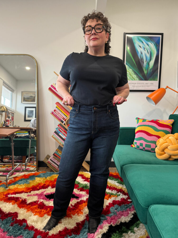 Alison Gary of Wardrobe Oxygen in her office wearing Talbots Straight Leg jeans and a black short-sleeved t-shirt