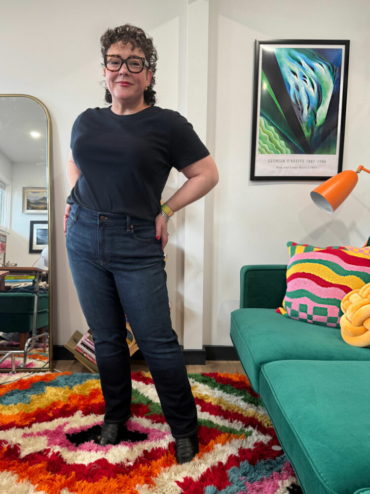 Alison Gary of Wardrobe Oxygen in her office wearing Talbots Straight Leg jeans and a black short-sleeved t-shirt