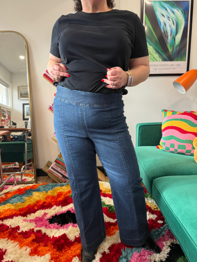 Alison Gary of Wardrobe Oxygen in a black t-shirt tucked into the Talbots Talbots Flare Leg Pull-on Travel Jeans