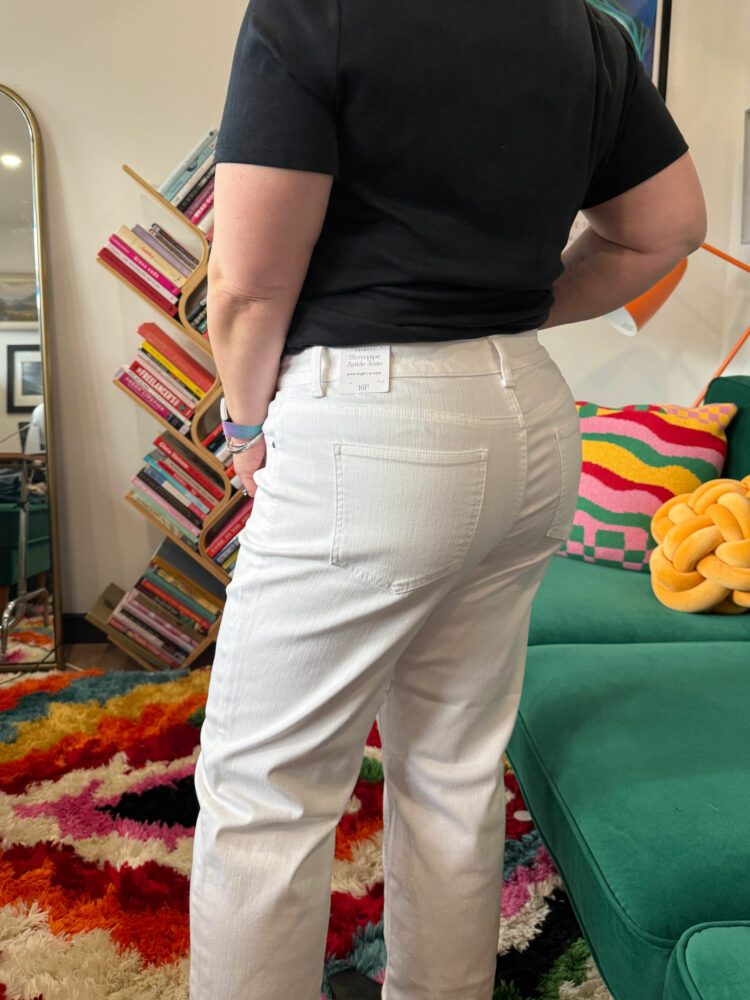 Alison in white mid rise stovepipe jeans from Talbots styled with a black t-shirt and black leather ankle boots.