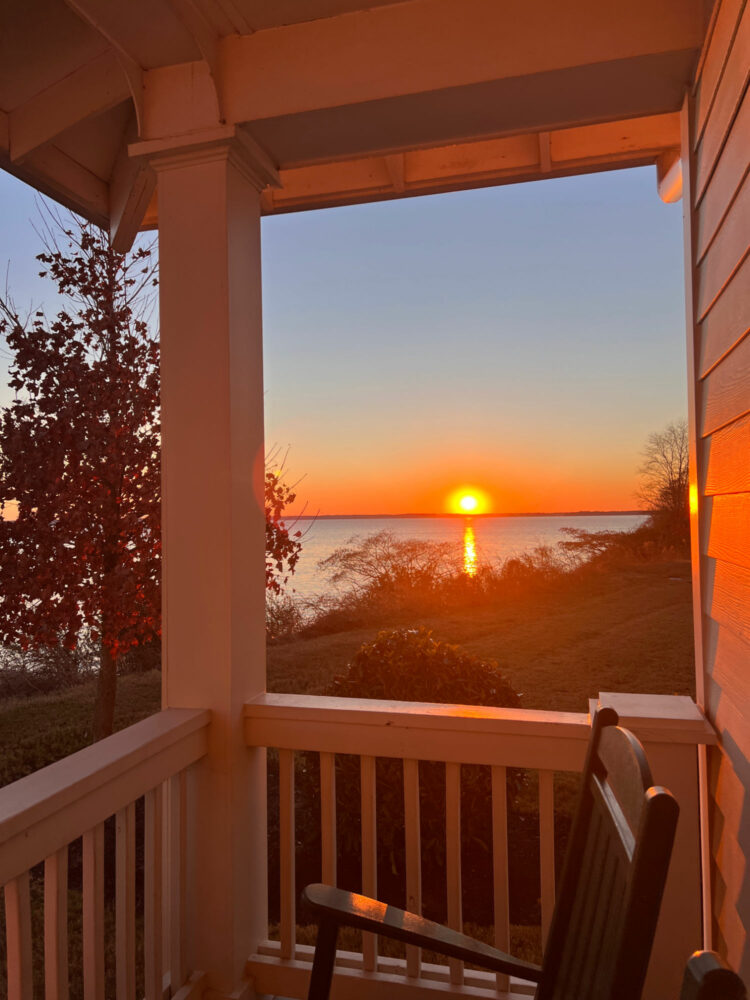 view of the sunrise on the james river from the balcony of a kingsmill resort cottage balcony